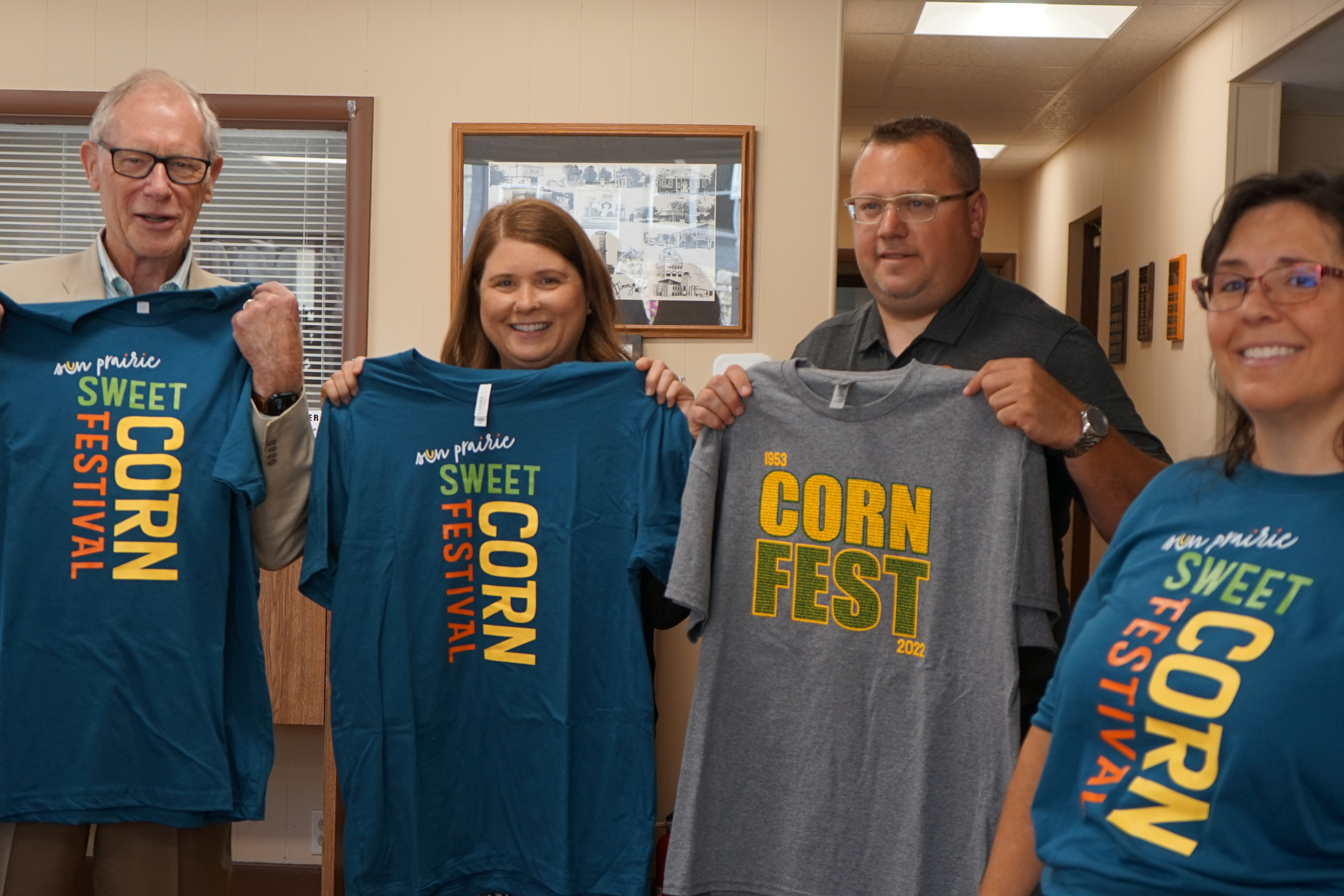 Sec. Blumenfeld and Sun Prairie Chamber of Commerce stakeholders display shirts with new branding for the Sun Prairie Sweet Corn Festival